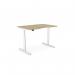 The image shows a modern round-shaped office desk with adjustable height capabilities. It has a dual purpose scallop design and measures 1200 x 800mm. The desk is finished in a sleek urban oak color with a white frame.