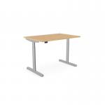 The photo shows a sleek and modern round desk with an aluminum portal for cords, 1400 x 800mm in size. The desk is height adjustable and has a beech top with a silver frame, perfect for any office environment.