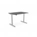 The image depicts a modern and sleek office workspace with a round sit-stand and height adjustable desk. The desk has a graphite silver frame and a 1400x800mm top with aluminum portals. The design allows for versatile and ergonomic use throughout the workday.