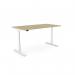 The image shows a modern and versatile office setup with sit-stand and height adjustable desks. The sleek round design features an Urban Oak top and a white frame, with built-in aluminum portals for easy access to cables. The desk measures 1600 x 800mm, making it spacious yet compact for any office space.