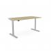 The picture shows a modern edit office with sit stand and height adjustable desks. The round desk top has silver frame and alu portals, measuring 1800 x 800mm. The desk is in an urban oak finish, giving it a sleek and contemporary look.