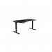 The image features a sleek, modern office set-up with a unique curvy height adjustable desk in black. The desk also features improved ergonomics with a sit-stand option and adjustable height. The black legs add a touch of sophistication to the office environment. The desktop size is 1600 x 800 and it is specifically designed for left-handed individuals. The top is also black, completing the overall stylish look.