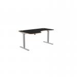 This image shows a modern office space with several curvy, height adjustable desks. The desks have grey legs and a black top, with a left-handed configuration. The overall dimensions are 1600 x 800, and the desks have a sleek, professional appearance.