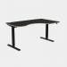 This photo shows a sleek, modern office setup with a curvy height adjustable desk featuring black legs and a black top. The desk also has a sit-stand function and measures 1600 x 800. It is specifically designed for right-handed individuals.