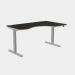 The photo features a sleek and modern office setup with a combination of sit-stand and height adjustable desks. The curvy grey legs add a unique touch, while the black top offers a professional look. The dimensions are 1600 x 800 and the desk is designed for right-handed use.
