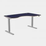 The image features a modern office space with various sleek, adjustable desks in different sizes. The desks have grey legs and a blue top, and one is specifically designed for right-handed individuals. The curvy design and height adjustability of the desks add a touch of versatility to the space.