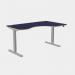 The image features a modern office space with various sleek, adjustable desks in different sizes. The desks have grey legs and a blue top, and one is specifically designed for right-handed individuals. The curvy design and height adjustability of the desks add a touch of versatility to the space.