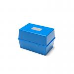 This picture features a small, compact blue box with the words ValueX and Deflecto printed on the front. The box has a hinged lid and is labeled as a Card Index Box in black lettering. The dimensions are listed as 5x3 inches (127x76mm). The background of the picture shows white index cards, hinting at the purpose of the box.