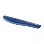 In the photograph, a plush blue wrist rest is shown placed beneath a keyboard. The wrist rest is made by Fellowes and features a soft, comfortable material for typing support. The brands name is visible on the wrist rest, with the product name PlushTouch Keyboard Wrist Rest written underneath. The wrist rest appears to be compact in size, fitting perfectly beneath the keyboard. The overall design is sleek and modern, making it a practical and stylish addition to any workstation.