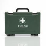The photo shows a compact blue and green first aid kit from Crest Medical with the BS 8599-1 (2019) certification. Its contents include essential travel supplies for emergencies on the go.