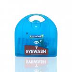 This photo features a Wallace Cameron Eye Wash Kit, displaying an Astroplast Piccolo Eye Wash Dispenser. The compact dispenser has a blue and white design, with clear labeling and a spout for easy access to eye wash solution. Boxes of additional eye wash are stacked behind the dispenser.