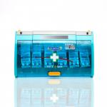 A photo of Crest Medical Plasters Astroplast Pull N Open Plaster Dispenser shows a sleek, white dispenser with the brand name and product logo on the front. Inside, there are 60 blue detectable plasters neatly organized and ready to use. Each plaster measures 7.2cm x 2.5cm. The dispense is compact and convenient for easy access to plasters in emergency situations.