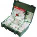 A photo of the Safety First Aid Group First Aid Economy Workplace First Aid Kit Large British Standard Compliant shows a red and white kit with a sturdy handle and clear labeling. It includes a variety of first aid supplies, such as bandages, antiseptic wipes, and scissors. The kit appears well-organized and ready to use in an emergency situation.