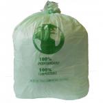 The photo shows a stack of compostable bin liners, each with a capacity of 90 litres. The sacks are a pale green color and are placed in front of a black and white striped background. The size of the liners is 737x965mm and the case contains 200 sacks.