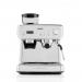 The photo shows a sleek Newell Brands Breville Barista Max+ Espresso Machine. It features intelligent grind and dosage settings, precision extraction timer, and an integrated milk frother, making it perfect for creating lattes and cappuccinos. The machine exudes modernity and sophistication, with a powerful steam wand and high-quality construction.