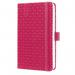 The photograph shows a bright fuschia pink diary from Sigel, featuring the words Slim Diaries and Sigel Jolie Diary 2026 on the cover. The A6 size and week-to-view layout are visible, as well as the elegant font and sleek design. The diary appears sophisticated and modern.