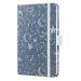 The image shows a blue Sigel Slim Diary with the title Jolie Diary 2026 written in elegant font. The cover features a cosmic fantasy design, with swirls of blue and white. The diary is an A6 size and has a week-to-view format.