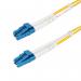 This image shows a bundle of StarTech Fibre Cables with LC to LC connectors, measuring 5m in length. The cables are made from OS2 single mode duplex fibre optic material, providing high-quality data transmission for various devices.