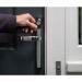 The photograph features a sleek and modern white Yale Conexis L2 Smart Door Lock. The lock is mounted on a door with a Yale logo visible on the handle. The lock is equipped with state-of-the-art security features and the keypad is illuminated with a soft blue light. The door is surrounded by a high-quality Yale Locks Security Equipment, highlighting its robust and reliable construction.