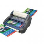 This picture shows a GBC RollSeal Ultima 35 Ezload Roll Laminator, featuring sleek grey and black design. The laminator has a large feed tray and control panel on top, with a transparent window showing the laminating process in action. The machine is on a sturdy base with four wheels for easy mobility.