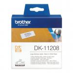 The photograph shows a stack of Brother DK11208 Large Address Labels with the label design Brother Brother Paper Labels 11111J visible. The labels are neatly stacked and ready for use. The white background contrasts with the bold black text, giving a professional appearance.