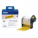 In the photo, there are yellow film tape labels from Brother DK22606. The labels have neat and precise black print of details such as names, dates, and numbers. The labels are on a paper backing and have a glossy finish. The roll of tape is neatly tucked into a labeled Brother box.