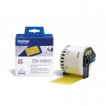The photograph shows several Brother paper labels in a bright yellow color, with the label Brother DK44605 visible on the packaging. The labels are removable and have a smooth, glossy finish. The label design features the Brother logo and product information.