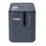 The Brother Label Makers Brother PT-P900WC Desktop Label Printer 33415J is a sleek and compact printer with a white and grey exterior. It has a built-in screen and multiple buttons for easy navigation. The label maker has a large printing area and comes with various fonts and designs to choose from. It also has a built-in cutter to easily separate the labels.