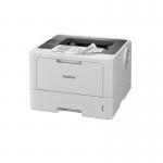 The photograph shows a sleek, modern Brother HL-L5215DN Mono Laser Printer with a glossy black exterior and a built-in LCD display. The printer is compact and stands upright, with a paper input tray at the bottom and a paper output tray at the top. The control panel includes buttons and a display screen, and the printer is in the process of printing a crisp, high-quality monochrome document.