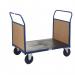 The picture features GPC Industries Ltds platform trucks with double timber ends measuring 1000 x 700. The trucks are designed for heavy-duty use and are in a striking yellow color. The platform is spacious and sturdy, providing ample support for transporting goods.