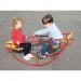 The photograph shows a 2 seater rocking boat designed specifically for school use. The boat is made of sturdy, polished wood and has smooth, curved edges. It features a large, flat platform for sitting. The front of the boat has two long, slender seats with high backs for comfortable seating. The back of the boat has two rounded handles for easy rocking motion. The surface is adorned with colorful, vibrant illustrations of various school stationery items like pencils, notebooks, and rulers. Overall, it is a fun and practical addition to any school playground.