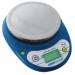 The photograph shows a compact balance by Adam, specifically designed for school use. It has a sleek and sturdy design, with a maximum capacity of 3000 grams and a precision of 1 gram. The stationery item is placed on a surface, with clear markings and numbers visible on the display. The compact size makes it convenient for use in classrooms or labs.