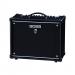 This photo shows a sleek black guitar combo amp, the Boss Katana 50 Mkii, sitting on a desk among colorful school supplies such as notebooks, pencils, and folders. Its 50 watts give off a powerful sound, making it perfect for school bands or jamming sessions with friends. Its compact size allows for easy transport and storage.
