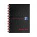 The photo of the Black n Red Books Black n Red Wirebound Hardback Ruled Notebook A6 (Pack of 5) shows five sleek, black notebooks with a red spine and secure wire binding. Each notebook has ruled pages, making them perfect for writing or taking notes.