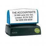 The photograph captures a Q-Connect custom pre-inked stamp, voucher and stamps in vibrant colors. The stamp measures 57x20mm and is surrounded by sleek packaging with the Q-Connect logo.
