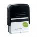 The picture depicts a Q-Connect voucher for a custom self-inking stamp measuring 57x20mm. The stamp is made of durable ink and has the Q-Connect logo engraved on it. It features a sleek design with a comfortable grip for ease of use. The voucher is clearly visible and contains all the necessary information for customization. The background showcases a modern office setting, suggesting the stamps functionality in professional environments.