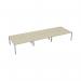 The Jemini 6 Person Bench Desk features a long 3600x1600mm surface with a sleek maple and white design. The desks are organized in a bench layout, creating a modern and collaborative workspace for six individuals.