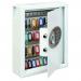 In the photograph, there is a sleek silver key cabinet with the words Phoenix Key Safe on the front. The cabinet is rectangular in shape and has a digital keypad on the front for access. Inside, there are 48 individual hooks hanging neatly, ready to hold keys of various sizes. The cabinet is mounted securely to a wall and has a small keyhole on the side for backup access. The overall appearance is professional and organized, making it a must-have for any business or organization.