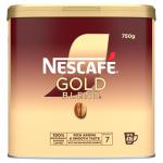 The photo shows a 750g jar of Nescafe Coffee Gold Blend Premium Freeze Dried Coffee. The jar has a sleek gold design with the Nescafe logo prominently displayed. The coffee inside has a rich, dark color and fine, powdery texture. The label proudly proclaims Premium Blend and New World Table in bold letters. A spoon sits next to the jar, ready to scoop out the rich coffee grounds.