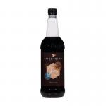 The image shows a 1 litre plastic bottle of Sweetbird Spiced Chai Coffee Syrup by Sweetbird Coffee Syrups. The label features warm colors and a picture of a steaming hot cup of chai. The syrup is made with natural ingredients and has a rich, spicy aroma.