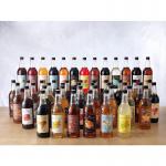 This photo shows a 1 litre plastic bottle of Sweetbird Passionfruit Lemon Iced Tea syrup from the Sweetbird Coffee Syrups line. The bottle features vibrant colors and the brands logo, with a label describing the product.