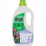 In the picture, Garden Maintenance Ecofective Organic Pour & Feed is shown as a pack of 6, with each container holding 1.5 liters of liquid. The label on the containers displays the brand name and product name. The liquid inside appears to be a rich, dark color. The background of the image is a garden scene with green foliage and blooming flowers. A watering can and gardening gloves can also be seen in the background.