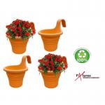 This image features a single terracotta planter from the Fixtures Hang Easy collection, perfect for adding a touch of green to your home or business. The planter is accompanied by a variety of stylish homeware items and garden maintenance tools.