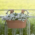 This photo showcases the Elho Garden Maintenance Elho Easy Hanger Large Twin in a beautiful terracotta color. The hanger is brand new and has a sleek and modern design. It is perfect for hanging and displaying plants in any garden or outdoor space.