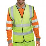 The photograph captures a bright yellow Beeswift high visibility waistcoat, featuring the logo of the company. The waistcoat is in medium size and made for adults, specifically designed for easy visibility and safety in busy work environments. It also includes the word Saturn on the front, indicating possible branding or design inspiration.