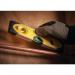 The photo shows a yellow and black Stanley tools torpedo spirit level that is 230mm in length. The level features a magnetic strip on one side and is shock resistant for durability. The level is designed with precision and has easy-to-read measurements.