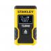 The photograph features the yellow and black Stanley Pocket Laser Distance Measure, a product from Stanley Black & Decker Tools. The sleek and compact design is apparent, with the clear and easy-to-read display on the top of the device. A single button in the center allows for simple operation, while the textured grip ensures a secure hold. The laser can measure distances up to 12m, making it a versatile tool for various home or professional projects.