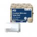 The photo shows a pack of 36 Tork Coreless Toilet Rolls, each 2-ply and natural in color. Included in the pack is a dispenser marked with the brand name Tork. The rolls and dispenser are neatly stacked together, ready to provide convenience and hygiene in any restroom setting.