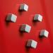 The image depicts a set of six sleek silver cube-shaped magnets, each 10x10 mm in size. They are labeled as strong and are part of the SIGEL GL192 SuperDym collection. The magnets come in a pack of eight, and are designed specifically for A4 sheets of paper that are 80 gsm.