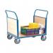 In the photo, two slingsby platform trucks from the Fetra brand are shown side by side. The trucks have double panel ended trays for added stability. Their sturdy frames and large wheels suggest they are designed for heavy-duty use.